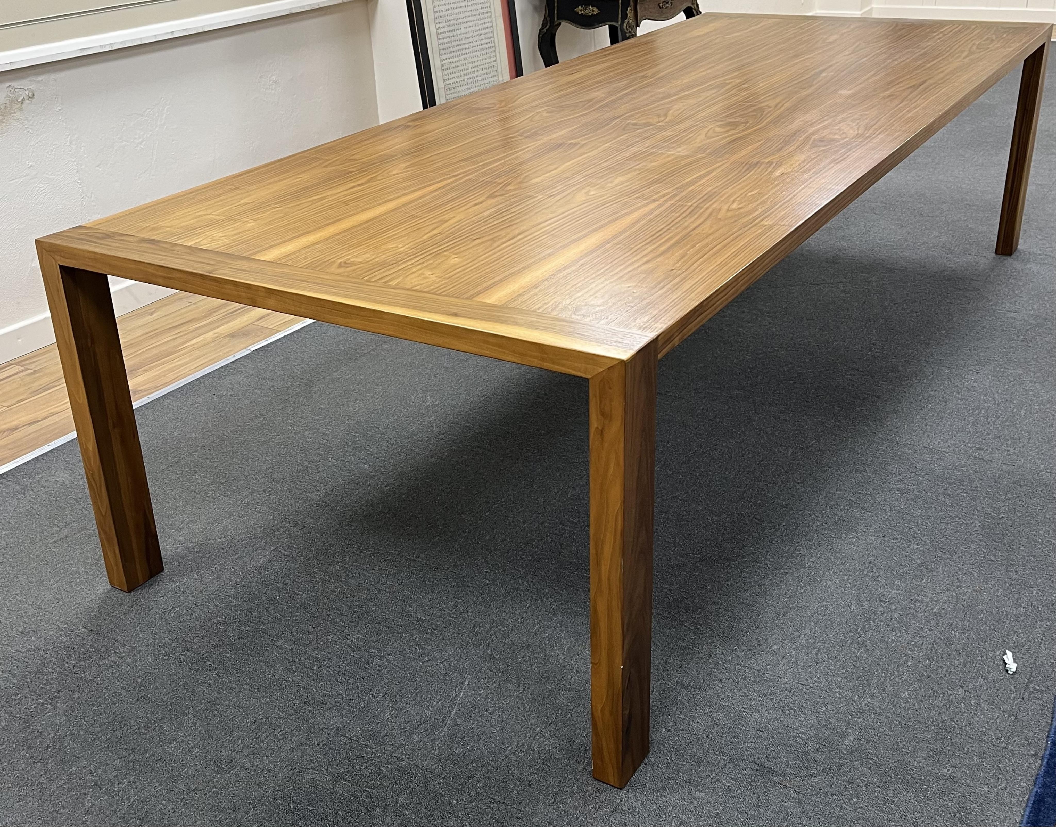 A Contemporary American black walnut dining table and ten chairs, by Chartwood designs Ltd, width 300cm, depth 120cm, height 75cm. Condition - fair